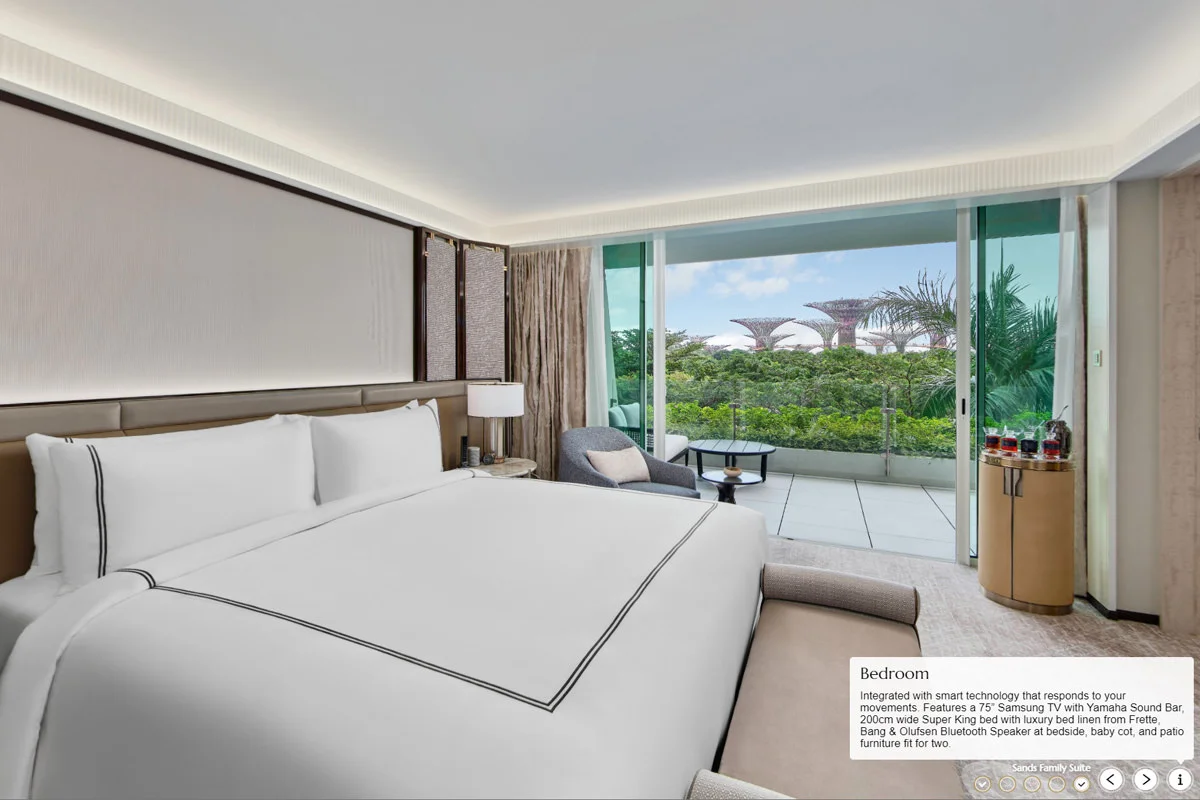 Marina Bay Sands Family Suite bedroom with king bed, balcony patio, and Gardens by the Bay Supertree views
